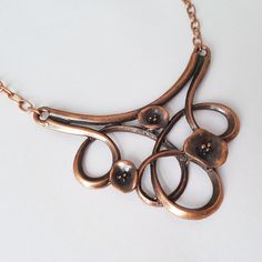 Huge antique copper plated floral art nouveau style bib is suspended on an antique copper plated large link chain.  The big antique copper plated flower swirl measures 3 inches (75 mm) across. The antique copper plated chain has a lobster clasp, and the length can be changed at no extra charge, please ask.  This necklace comes in a gift box. Also available separately in antique bronze, and antique silver plated. More statement necklaces here: http://etsy.me/2vFXH9q Vintage Bronze Jewelry With Artistic Design, Artistic Bronze Copper Necklace, Bronze Art Nouveau Jewelry With Antique Finish, Antique Bronze Copper Necklace, Victorian Bronze Copper Necklace, Vintage Electroformed Copper Necklace, Mood Stone, Bronze Art, Crescent Earrings