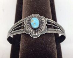 (eBay) A vintage Fred Harvey sterling silver bracelet with a turquoise cabochon center.