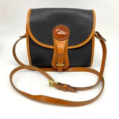 All Weather Leather Crossbody Vintage C. 1985 To Mid 1990s Black Pebbled Finish With Tan Trim (Series R Colors) Easy Closure Interior Pockets Boxy Roomy Shape For A Smaller Bag Note Wear To Corners Serial Number A6 598634 Made In The Usa Genuine Leather With Suede Side Interior Approximate Measurements: Strap Drop 20”-24” Base 8”X3.5” Height 7.75” Useable Height 6.25” Width 7.5” Opening 7”X3.5” Vintage Black Bags With Leather Trim, Vintage Black Bags With Leather Backing, Vintage Black Shoulder Bag With Leather Backing, Vintage Black Satchel Saddle Bag, Vintage Black Saddle Satchel Bag, Vintage Black Leather Saddle Bag, Vintage Black Saddle Bag For Travel, Tan Trim, Leather Handbags Crossbody