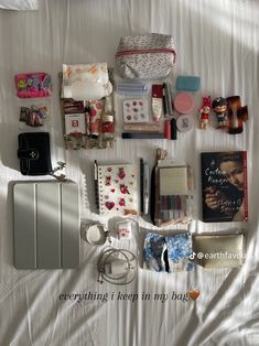 an assortment of personal items laid out on a bed