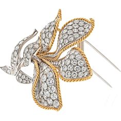 Relish in the confluence of style and substance with the Platinum & 18K Yellow Gold 25.00 carat total weight Diamond Flower Brooch, a testament to timeless elegance and exquisite craftsmanship. This magnificent brooch exudes luxury and sophistication, making it a coveted addition to any fine jewelry collection.At the heart of this masterpiece is a breathtaking 25.00 carat total weight of round diamonds, showcasing F-G color and VS-SI clarity that dazzle with every movement. The intricate design of the flower motif is a symbol of natural beauty and grace, meticulously crafted in platinum and 18K yellow gold for a harmonious blend of precious metals.Whether adorning an evening gown or adding a touch of glamour to everyday attire, this brooch is a versatile statement piece that captures atten Diamond Flower Brooch, Gold Beauty, Diamond Birthstone, Flower Motif, Diamond Flower, Fine Jewelry Collection, Intricate Design, Relish, Flower Brooch