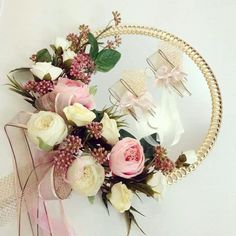 a bouquet of flowers sitting in front of a mirror with hair combs on it