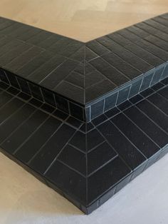 two black tiles sitting on top of each other