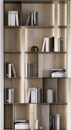 the bookshelf is made out of wood and has many different types of books on it