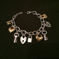 Carlo charm bracelet Heavy metal fashion jewelry, two-tone bracelet with 9 charms, three of which (the hearts) are in gold tone, bold and fun. Bought in England, never worn. Carlo Jewelry Bracelets Silver Heart Charm Chain Bracelet, Silver Metal Chain Bracelet For Valentine's Day, Silver Metal Chain Bracelet With Heart Charm, Valentine's Day Silver Metal Chain Bracelet, Silver Metal Heart Bracelet With Charms, Metal Charm Bracelet With Lobster Clasp For Anniversary, Nickel-free Metal Charm Bracelet For Valentine's Day, Nickel Free Silver Metal Heart Bracelet, Nickel-free Silver Metal Heart Bracelet