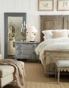 a bedroom with a bed, dresser and mirror in it's centerpieces