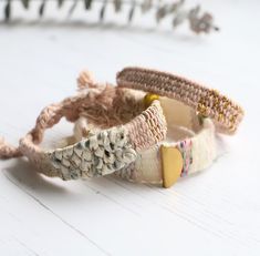 three bracelets are sitting on a white table