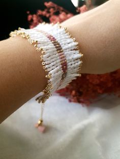 a close up of a person's arm wearing a bracelet with beads on it