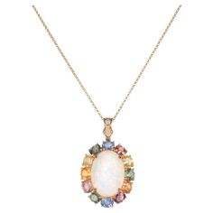 Glamorous Gemstones - Sunita Nahata started off her career as a gemstone trader, and this particular collection reflects her love for multi-colored semi-precious gemstones. The pieces in this collection are exclusively curated by Sunita to present unique items that incorporate fancy and exclusive gemstones cuts and color combinations. 6.17 Carat Opal Pendant in 18 Karat Yellow Gold with Multi Sapphire and White Diamond. Opal: 6.17 carat, 18X13mm size, Cabochon cut, Oval Shape. Multi Sapphire: 5.40 carat, 5X4mm size, Oval Shape. White Diamond: 0.038 carat, 2.00mm size, Round Shape, G Colour, VS clarity. Gold: 4.83g, 18K Yellow gold. P182 Multi Sapphire, Opal Pendants, Unique Items, Precious Gemstones, Cut And Color, Semi Precious Gemstones, White Diamond, Oval Shape, Multi Colored