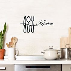 a kitchen wall decal with utensils and pots on the counter top next to an oven