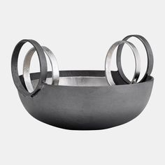 a metal bowl with two rings on it