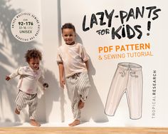 two children standing next to each other in front of a sign that says lay - pants for kids