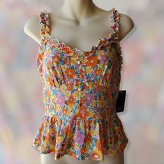 Sweet And Chic Floral Peplum Top By The Brand Fifty Street In Size M/Medium. This Is Such A Fun Vibrant Top With Classic Vintage-Feel Due To Variety Of Floral Prints In Pink/Orange/Yellows. Frilly Style Shoulder Straps, Heart Neckline And Stretchy Waist. The Fabric Is So Soft And Feels Very Comfortable! Brand New Condition With Tags Attached. Summer Feminine Floral Print Peplum Top, Spring Beach Sleeveless Peplum Top, Spring Beach Peplum Top, Spring Sleeveless Peplum Top For Beach, Sleeveless Peplum Top For Spring Vacation, Sleeveless Peplum Top For Beach In Spring, Sleeveless Peplum Top For Spring Beach Occasion, Spring Vacation Fitted Peplum Top, Summer Vacation Fitted Peplum Top