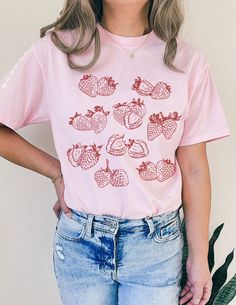 Strawberry Cottagecore Vibe Cute Fruit Shirt🍓 SIZING & MATERIALS: Printed on Unisex Comfort Colors c1717 garment-dyed t-shirt for a relaxed fit; the fabric brings extra coziness to your wardrobe while the relaxed fit makes it an excellent daily choice.  .: 100% ring-spun cotton .: Medium fabric (6.1 oz/yd² (206.8 g/m *Sizing down one size will give you a more fitted look* *Sticking with your normal size gives a nice relaxed look* *Sizing up 1-2 sizes gives an oversized look* Please compare meas Pink Short Sleeve Top With Screen Print, Casual Pink Tops With Screen Print, Spring Short Sleeve Tops With Screen Print, Pink Cotton Top With Graphic Print, Pink Printed Cotton Tops, Printed Pink Cotton Tops, Pink Soft-washed Graphic Tee, Tri-blend Crew Neck Top For Summer, Casual Pink Soft-washed Shirt