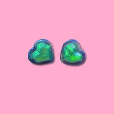 Size- 3/4" Tall, 3/4" Wide. Color- Peaceful Vibrance, Everything Bagel Pink Heart Lab Created Stud Earrings! Earrings are Handcarved meaning each Gummy Bear differs slightly from each other! Each Earring will have a different flash, color wave, and carved details. Since these are legitimately handcarved in studio, they are not going to be identical!  NOTE:  Besides these being unique and one of a kind, we didn't want to take the chance of something going wrong while carving, so we made the decision to leave the posts on the back of the Gummy, without embedding it. This does not change the durability/wearability of these studs, they will hold up perfectly fine, and don't hesitate to contact us if you need any help or have any questions!  PROCESS:  We take the Opal from the Manufacturer, and Green Heart Charm Earrings For Valentine's Day, Green Heart Earrings For Valentine's Day, Nickel Free Green Heart Earrings, Green Heart-shaped Earrings For Valentine's Day, Green Heart Beads Earrings For Gift, Green Earrings With Heart Beads For Gifts, Nickel-free Green Heart Earrings, Green Heart-shaped Earrings For Gifts, Cute Green Heart Earrings For Gift