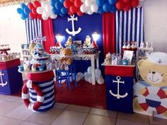 a birthday party setup with balloons, decorations and teddy bears on the table in front of it