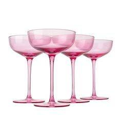 three pink wine glasses sitting next to each other