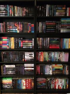 a bookcase filled with lots of books and dvds on top of eachother