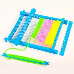 a pair of green and yellow toothbrushes next to a plastic comb holder