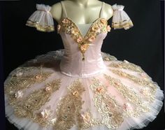 a pink and gold ballerina dress on a mannequin