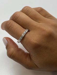 a woman's hand with a diamond ring on it