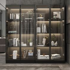 a book case filled with lots of books on top of glass shelves next to a couch