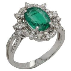 This gorgeous emerald and diamond ring is set in 18K white gold. Perfect for a birthday, anniversary or any other special occasion, it features an oval emerald that weighs 1.91 carats and is surrounded by around 0.61 carat of round diamonds. This elegant ring also has a total of 4.75 grams in weight, making it a bold yet delicate statement piece to be enjoyed for years to come. Allure Jewellery Mfg. Co., Ltd. stands out due to its quality, expertise, exclusivity and gives clients that "wow” fact Green Oval Emerald Ring In Platinum, Oval Emerald Ring In White Gold With Diamond, Oval Emerald Ring With Halo Setting In Platinum, Elegant Oval Platinum Emerald Ring With Halo Setting, Oval Platinum Emerald Ring With Halo Setting, Oval Emerald Ring With Prong Setting In Platinum, Oval Platinum Emerald Ring With Prong Setting, White Gold Emerald Ring With Diamond Accents, Oval Shape, Oval Emerald Ring In White Gold With Diamond Accents