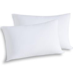 two white pillows sitting next to each other