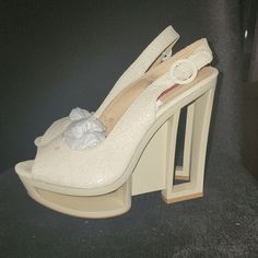 With It's Modern And Structured Silhouette, The C Label Dolce-2c Cut-Out Slingback Is A Statement Sandal You Must Add To Your Closet. The Eye-Catching Heel Features A Textured Faux Leather Upper, Slingback Style, Sexy Peep-Toe And 5 3/4¾" Cutout Wedge Heel With 1 1/2" Platform Cream Open Toe Synthetic Slingback Pumps, Cream Slingback Pumps For Spring Party, Luxury Cream Slingback Pumps For Party, Designer Cream Slingback Heels, Chic Cream Slingback Pumps For Party, Cream Open Heel Slingback Pumps For Party, Cream Slingback Pumps With Heel Strap For Parties, Designer Cream Sandals For Party, Silver Platform Shoes