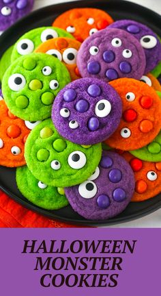 halloween monster cookies on a black plate with purple and orange sprinkles in the middle