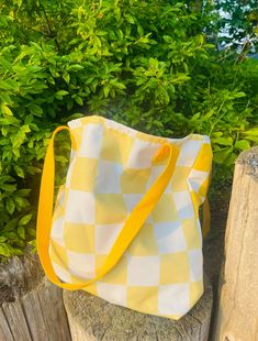 A spacious and trendy tote bag to help you carry around everything that matters. 😎 I happily fit my Macbook in here for my coffee runs! 💻   Please note: this bag does not have pockets inside. * 100% spun polyester fabric * Bag size: 15″ × 15″ (38.1 × 38.1 cm) * Capacity: 2.6 US gal (10 l) * Maximum weight limit: 44lbs (20 kg) * Dual handles made from 100% natural cotton bull denim * Handle length 11.8″ (30 cm), width 1″ (2.5 cm) Checkered Bag, Yellow Tote Bag, Trendy Tote Bags, Beach Gifts, Summer Gifts, Trendy Tote, Fabric Bag, Beach Bag, Natural Cotton