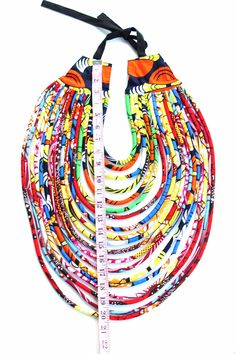 Priceless Culture makes you stand alone with this amazing African Print Multi-strand necklace!! Make a bold statement and stand out of the crowd!! You're sure to get all the attention with these beautiful African Jewelry!! View Jewelry on Model: https://www.etsy.com/listing/535128413/african-print-multistrand-necklace?ref=shop_home_active_1 This jewelry are awesome fashion accessory for any event, occasion and even to the office. Your bridesmaids will shine in these earrings and they make great African Accessories, Afrikaanse Mode, African Necklace, Set Apart, Fabric Necklace, Printed Jewelry, African Wax Print, Textile Jewelry, African Jewelry