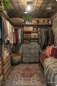 an organized closet with drawers, rugs and clothes hanging on the wall next to it