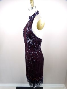 "This is an EXQUISITE vintage cocktail dress beautifully detailed and hand embellished with glass beading. It's in excellent condition! Bust - 33\" Waist - 27\" Hips - 38\" Length - 36-41\" Tag Size - Medium This dress comes from a pet-free and smoke-free home. If you would like more info or have any questions, please don't hesitate to ask!" Sleeveless Cocktail Evening Dress With Beaded Fringe, Glamorous Beaded Cocktail Dress, Beaded Sleeveless Sequin Dress For Formal Occasions, Sleeveless Beaded Sequin Dress For Formal Occasions, Formal Sleeveless Sequin Dress With Beads, Sleeveless Beaded Sequin Dress For Evening, Hand Embellished Fitted Dress For Party Season, Formal Sleeveless Beaded Sequin Dress, Hand Embellished Sleeveless Party Evening Dress