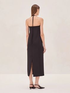 Introducing the Sezane Midi Dress—a modern piece with a sleek halter neckline, accentuated by a distinctive gold square detail. This midi dress features a streamlined silhouette that falls elegantly, offering a clean and contemporary look. Perfect for both day and evening, the Sezane Midi Dress is versatile in its simplicity, allowing for easy styling whether dressed up with heels or kept minimal. A true go-to for a polished and effortless appearance. Sezane Dress, Skirt Jumpsuit, Halter Neckline, Instagram Shop, Skirt Pants, Short Pants, Jacket Tops, Blazer Jacket, Jumpsuit Romper