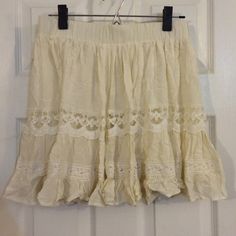 New With Tags. Beige Color With An Under Layer. Size Medium. Beige Skirt With Lace Trim For Spring, Beige Bottoms With Lace Trim Flowy Design, Summer Beige Skirt With Lace Trim, Beige Lace Trim Skirt For Spring, Bohemian Cotton Mini Skirt For Day Out, Cream Flared Skirt For Summer, Summer Mini Skirt With Lace Trim, Bohemian Short Mini Skirt For Spring, Cream Ruffled Mini Skirt For Summer