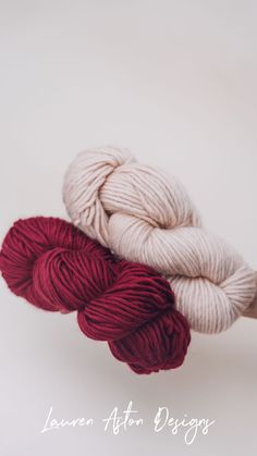 two skeins of yarn sitting on top of each other in front of a white background