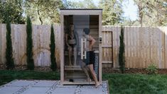 two people in a wooden sauna outside