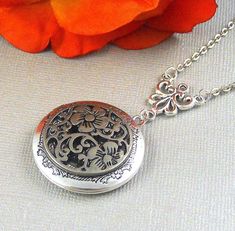 This elegant locket is 28 inches long. Antique finished round silver locket has beautiful engraved floral patterns on the sides. I have set a antique silver finished gothic style medallion filigree on the locket. Necklace is hanging from antique silver link. Heirloom locket is finished with antique silver chain and silver lobster clasp. Locket is 32mm in size. It has room for two photos inside! Please note: I DO NOT DO ENGRAVING OR INSERT PICTURES! Thanks for looking:) Mani Ornate Silver Jewelry With Engraving Option, Victorian Silver Jewelry With Engraving Option, Silver Medallion Wedding Jewelry, Antique Silver Locket Necklace For Wedding, Silver Filigree Medallion Locket Necklace, Nickel-free Silver Locket Necklace For Wedding, Nickel Free Silver Locket Necklace For Wedding, Ornate Silver Locket Jewelry, Silver Medallion Locket Necklace For Wedding