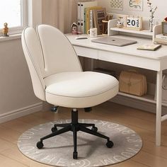 a white desk chair sitting on top of a rug in front of a computer desk