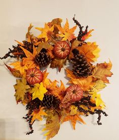 a wreath made out of leaves and acorns