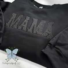 Elevate your mom style with our Mama Black Embroidered Glitter Vinyl Crewneck Sweatshirt! Made with high-quality materials, this cozy black sweatshirt is embroidered with the word "Mama" in a bold and chic font. The shimmering black glitter vinyl adds a touch of glamour, while the crewneck design provides comfort and style. Perfect for any mama looking to show off her love and style at the same time! THIS IS A PHYSICAL PRODUCT. CREWNECK IS UNISEX. CREWNECK IS EMBROIDERED. CREWNECK CONTAIN GLITTE Rhinestone Hoodie, Glitter Heat Transfer Vinyl, Nurse Hat, Crewneck Design, Embroidered Crewneck, Easter Outfit, Black Sweatshirt, Thanksgiving Outfit, Glitter Vinyl