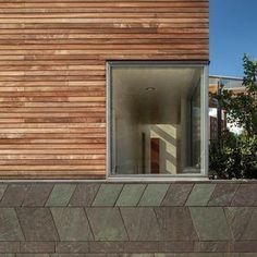 an open window on the side of a wooden building