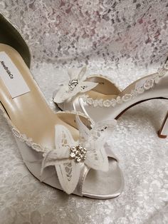 Gorgeous White or Ivory High heels, elegantly embellished with fine buttemburg lace bow and crystals center! I had the bows specially made by an European house of laces, Silver Austrian crystals embellishes the bows centers, and for those brides who are looking for a modern-retro look the edging lace is Vintage Venice lace; very feminine shoe design Please look at my unique artistic designs and compare my prices and the quality of my work; You won't find anything quite like it in any other shops Ivory High Heels, Crystals White, Feminine Shoes, Goth Shoes, Battenburg Lace, Blue Wedding Shoes, White Wedding Shoes, Mid Heel Shoes, Satin Shoes