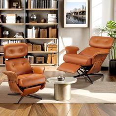 two chairs and a coffee table in a room with bookshelves on the wall