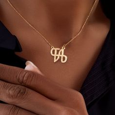 Personalize Your Style with Our Logo Name Necklace. Crafted with precision and attention to detail, this necklace is the perfect way to showcase your personal style. Metal: Stainless Steel Available in a variety of finishes: 🌹 Rose Gold 🟡 18k Gold 🥈 Silver 🌹 Iced Rose Gold + 💎 Cubic Zirconia 🟡 Iced 18k Gold + 💎 Cubic Zirconia 🥈 Iced Silver + 💎 Cubic Zirconia The chain length options include: - 16" - 18" - 20" - 22" Each necklace is meticulously: ✨ Designed ✨ Polished ✨ Assembled Please note: All our items come with a 5 cm/2" extension chain. so don't hesitate about the size!! * 14" NECKLACE: Fits most like a choker * 16" NECKLACE: Falls perfectly around the base of the neck like a collar. On a petite woman it will hit your collarbone while for plus size women it might feel more li Formal Initial Necklace, Formal Initial Pendant Necklace, Elegant Gold Initials Necklace, Elegant Gold Initial Pendant Name Necklace, Formal Initial Pendant Charm Necklace, Elegant Gold Chain Necklace - Gift For Her, Elegant Gold Chain Necklace As A Gift For Her, Gold Initial Pendant Name Necklace For Mother's Day, Initial Pendant Necklace With Delicate Chain For Anniversary