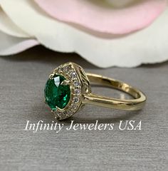 "The ring pictured is lab created emerald and moissanite #6410 We feature the finest quality lab grown emeralds in the world. The properties of lab-grown are physically, chemically and visually identical to natural, just grown in a lab setting. Emerald is the birthstone of May -Approximate total carat weight: 1.46 ctw diamond equivalent -Center Stone Size: approx. 1.20ct diamond equivalent -Center Stone Shape: round - extra brilliant 7mm -Gem Type: lab created emerald -Stone Clarity: VS2 -Stone 14k Gold Green Halo Ring, 14k Gold Emerald Ring With Halo Design, Formal Emerald Halo Ring For May Birthstone, Classic Moissanite Wedding Ring For May Birthstone, Green Emerald Cut Halo Jewelry, Green Emerald Jewelry With Halo Detail, Green Emerald Halo Jewelry, Heirloom Green Halo Jewelry, Classic Emerald Jewelry With Halo