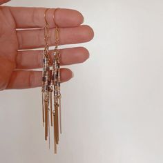 BEADED FRINGE EARRINGS |FEATURES|: -earrings measure 4" (at longest fringe) -11/0 delica beads in ivory, olive drab + gold -gold plated link detail -brass hook |CARE INSTRUCTIONS|: Brass oxidizes over time, giving it a vintage look. Oxidation can be removed with a soft cloth, if desired. Exposure to water can expedite the oxidation process.  |PRODUCTION TIME|: Usually within 3-5 business days (excluding weekends + holidays). Please message for any rush orders. |SHIPPING TIMES (transit times once your order has shipped US orders ship USPS First Class Mail, 3-5 business days. Adjustable Gold Bohemian Tassel Earrings, Metal Tassel Fringe Drop Earrings, Adjustable Gold Tassel Earrings With Fringe, Bohemian Metal Tassel Earrings With Fringe, Gold Fringe Metal Chandelier Earrings, Gold Fringe Chandelier Earrings, Elegant Brass Tassel Earrings, Gold Fringe Earrings In Brass, Elegant Tassel Earrings In Brass