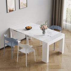 a white table with blue chairs around it