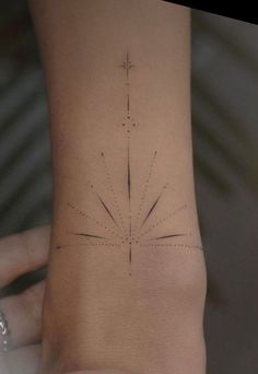 a woman's foot with an arrow tattoo on it